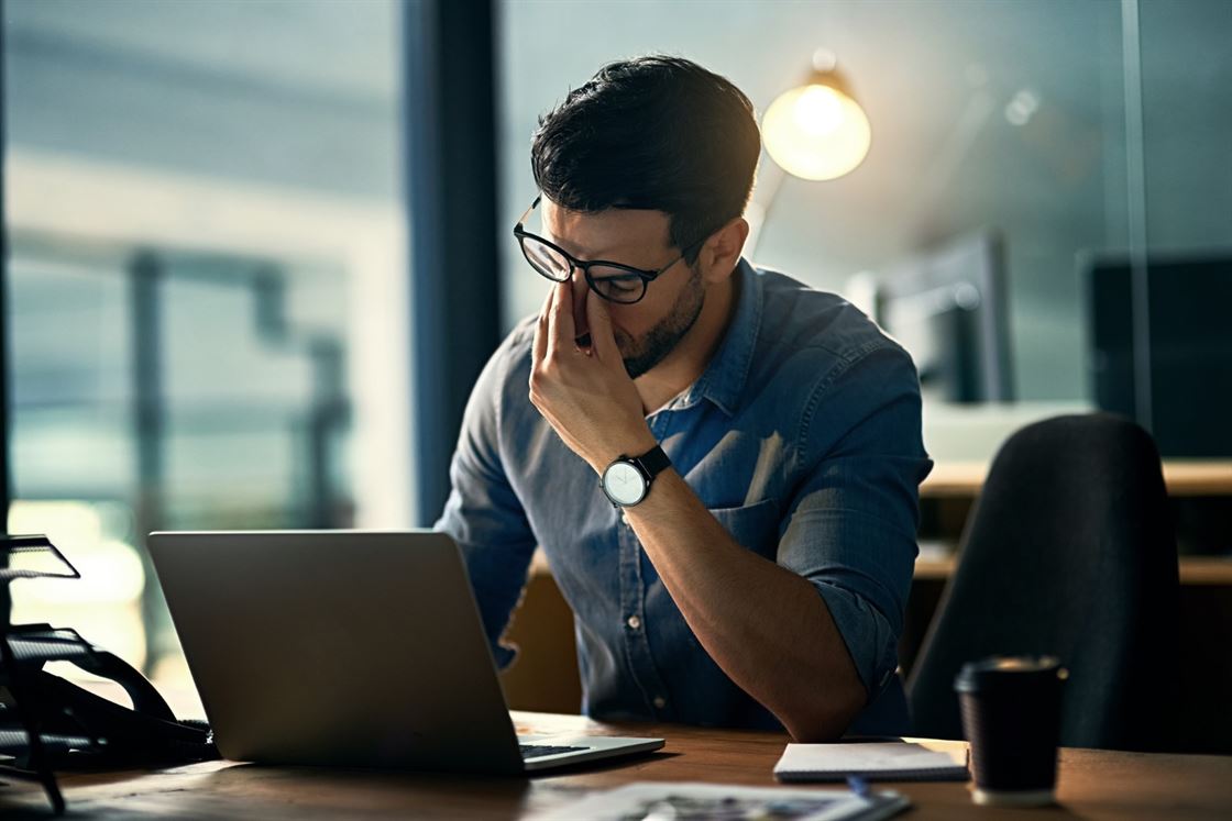 A person touching his face while looking at a computer

Description automatically generated